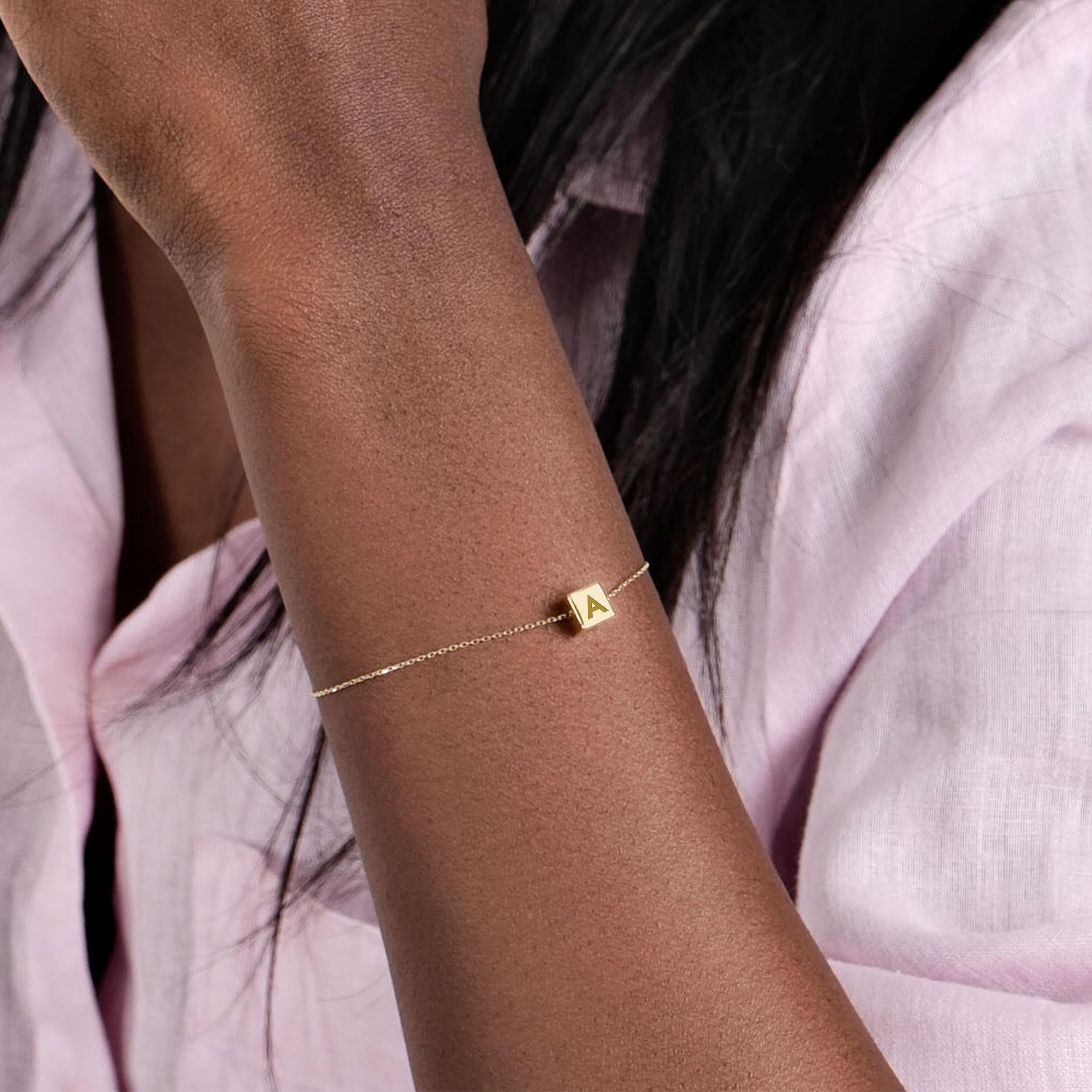 14K Solid Gold Cube Initial Bracelet – A minimalist gold chain bracelet with an adjustable clasp and a personalized cube charm.