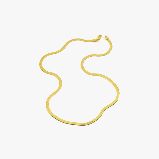 Flat-lay product image of an 18K gold vermeil personalized herringbone necklace featuring engraved names “Emily ♥ James.”