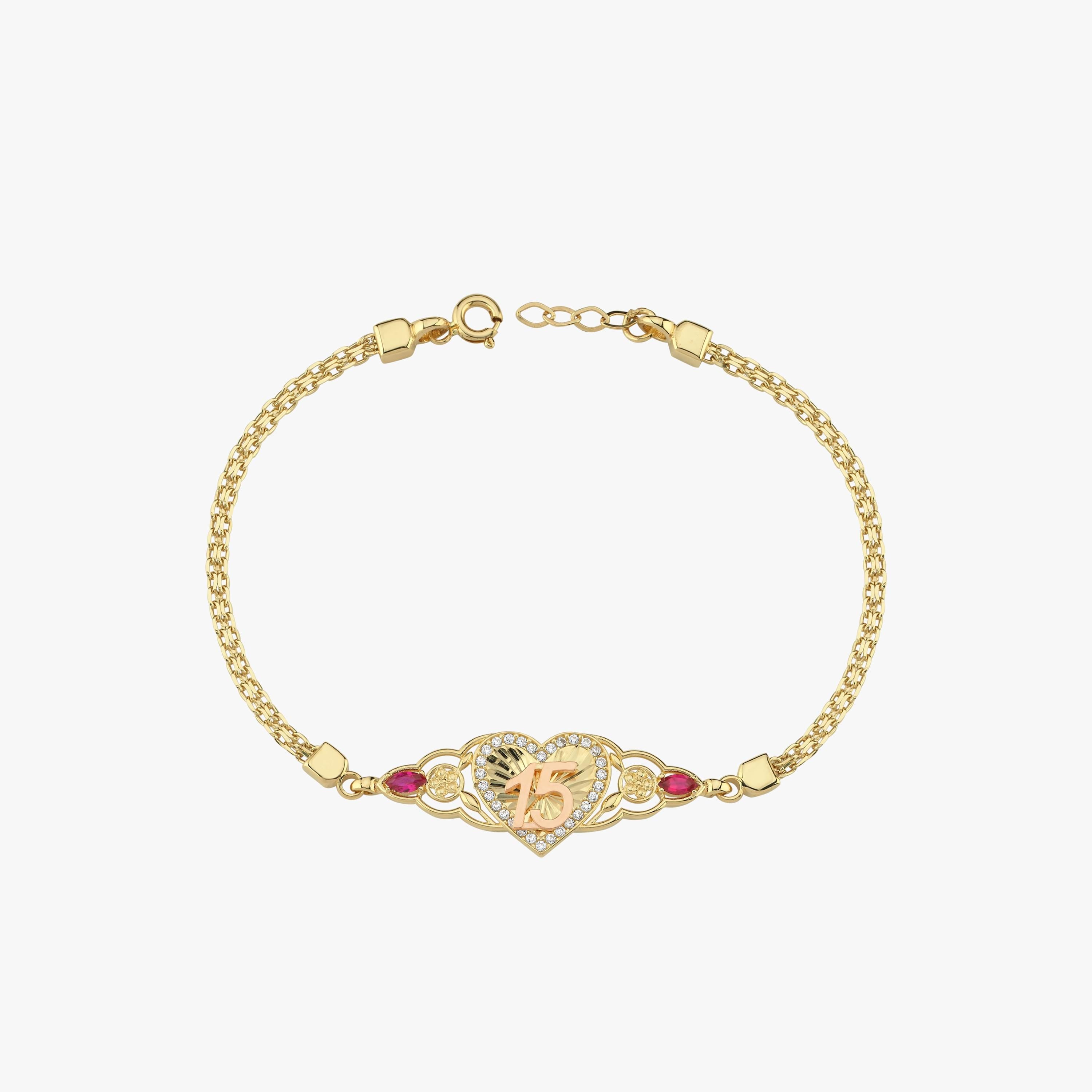 A gold Quinceañera Gift bracelet featuring a "15" heart charm and red gemstone accents, displayed against a clean background.