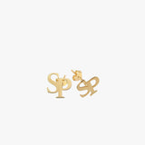 Detailed shot of 14K solid gold intertwined initial earrings with butterfly backings, displaying the “S” and “P” monogram design.