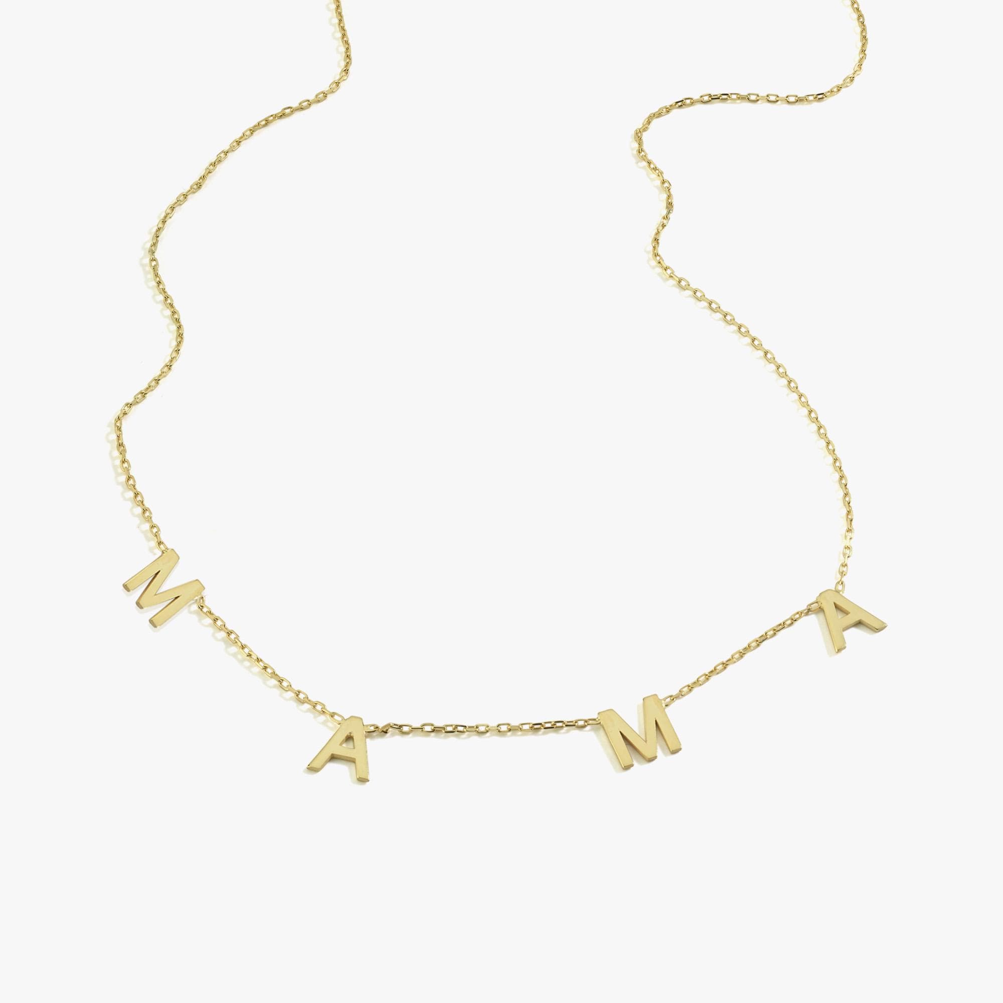 Isolated product shot of a 14K solid gold mama necklace on a white background, showing the fine chain and bold letter charms.