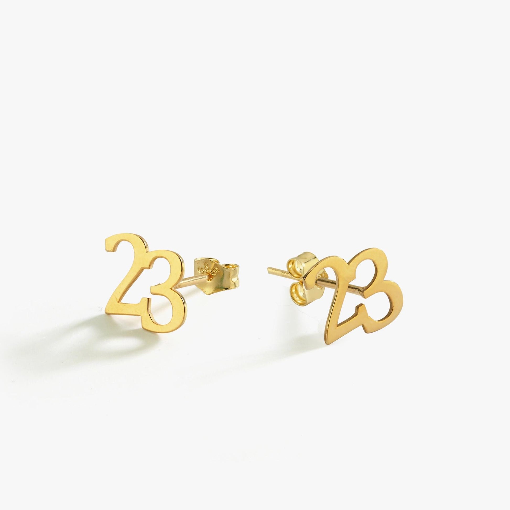 Product shot of 14K Solid Gold Number Stud Earrings with the number “23” in polished yellow gold, displayed on a white background.