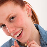 Smiling model showing matching sapphire birthstone necklace and 18K gold vermeil earrings for a complete birthstone set.