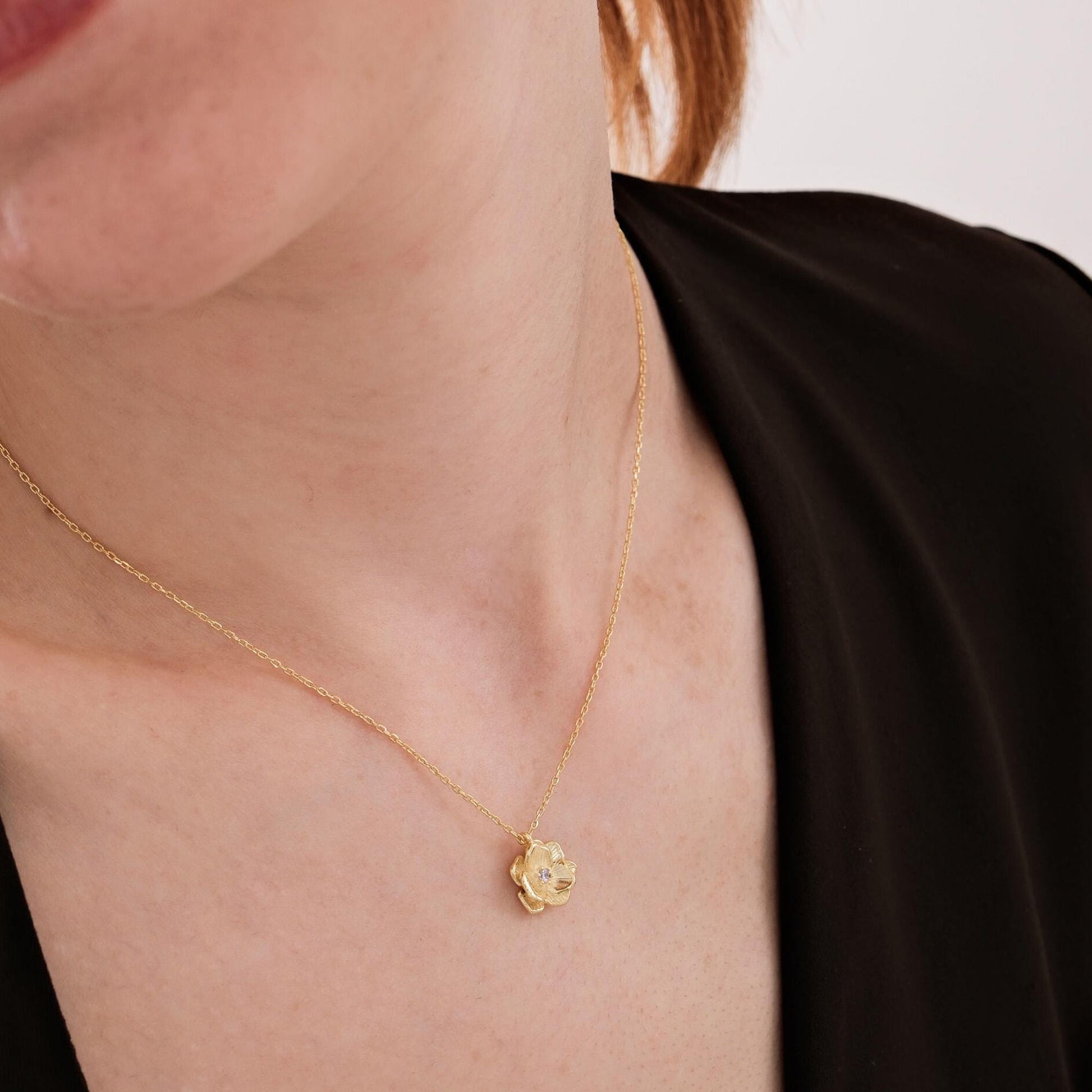 Delicate 18K gold vermeil birth flower jewelry featuring a diamond pendant, styled elegantly on the neck.