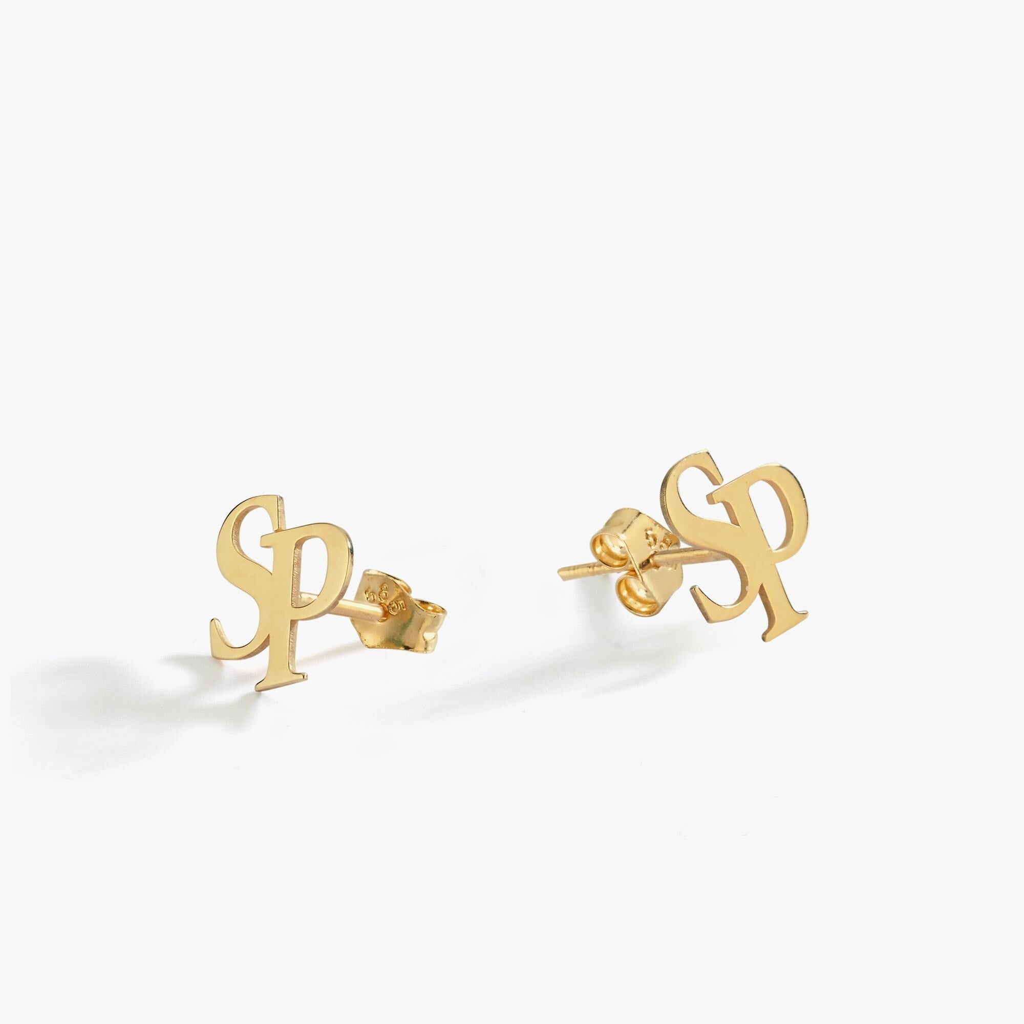 Pair of 14K solid gold intertwined initial earrings on a white background, designed with overlapping “S” and “P” letters.