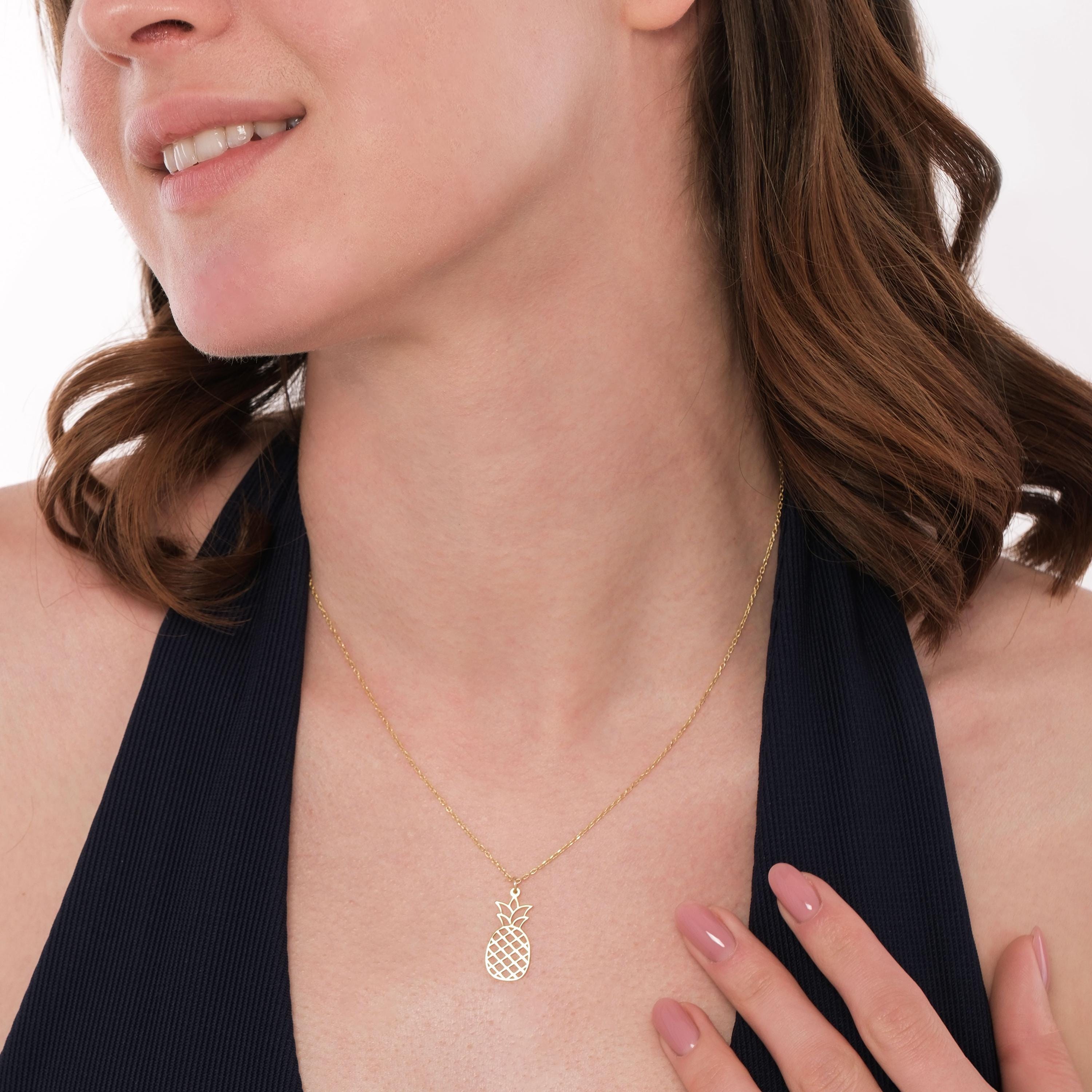 Styled with a neutral outfit, the 14K Solid Gold Pineapple Fruit Necklace adds a subtle yet playful touch.