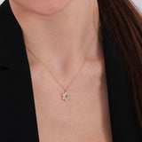Front view of a 14K solid gold Star of David pendant resting on a woman's chest, styled with a black blazer.