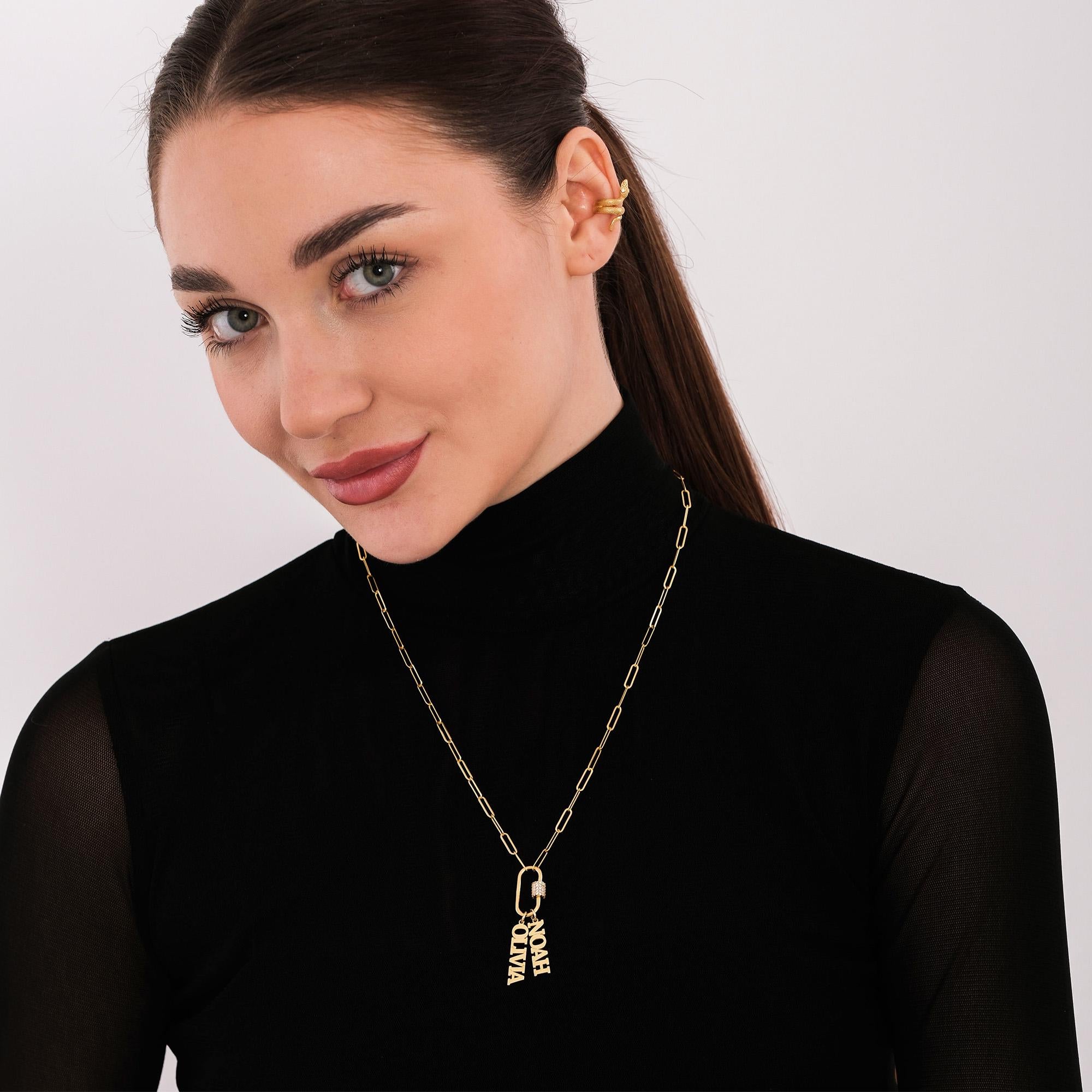 Paperclip chain gold vermeil carabiner charm necklace with custom letter pendants, displayed as a coiled flat lay on white surface.