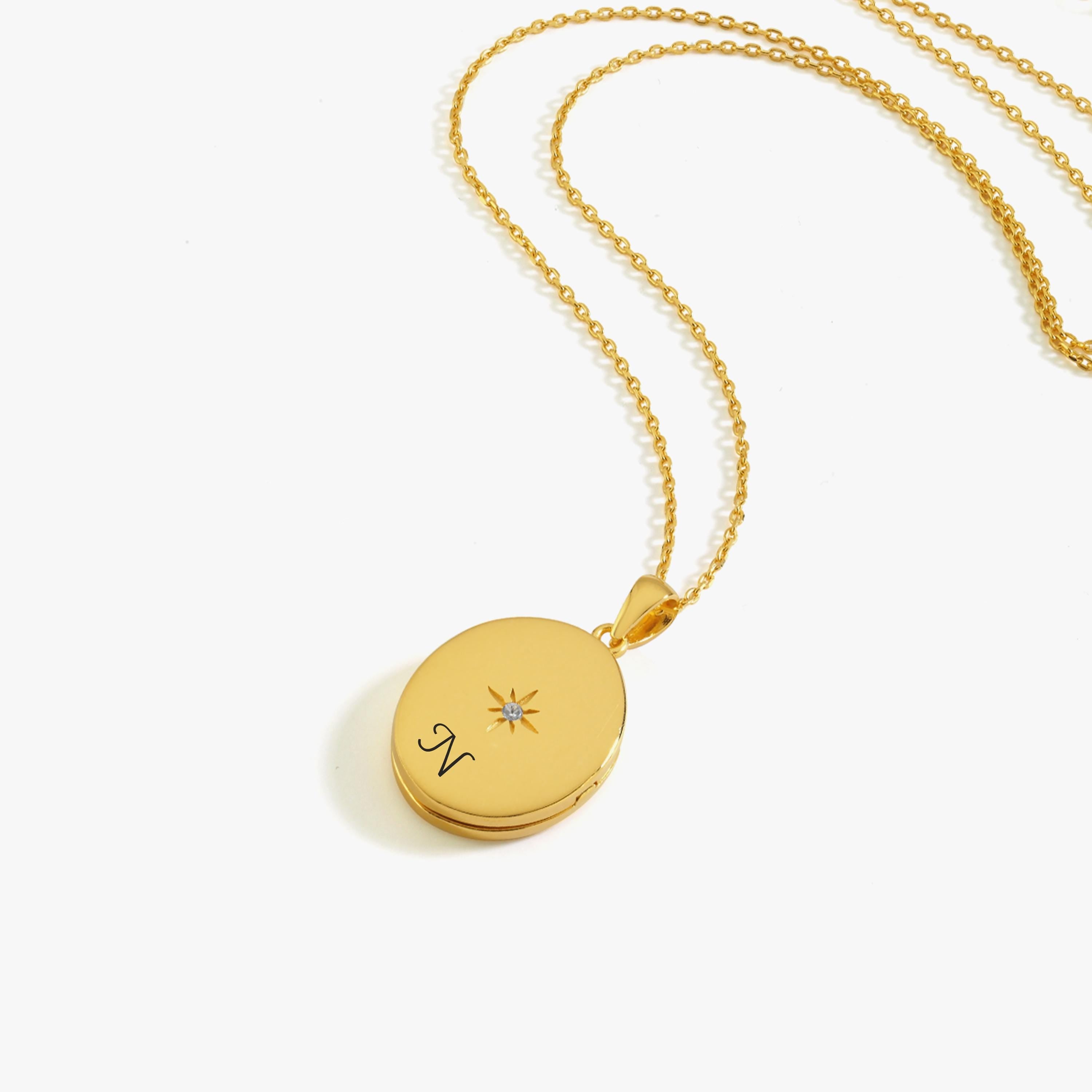 The 18K Gold Vermeil Photo Locket Necklace displayed on a white background with a dainty chain and compass design.