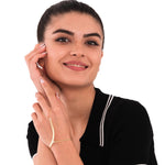 Smiling woman modeling an 18K gold vermeil slave bracelet, displaying the elegant chain and bar structure across her hand.
