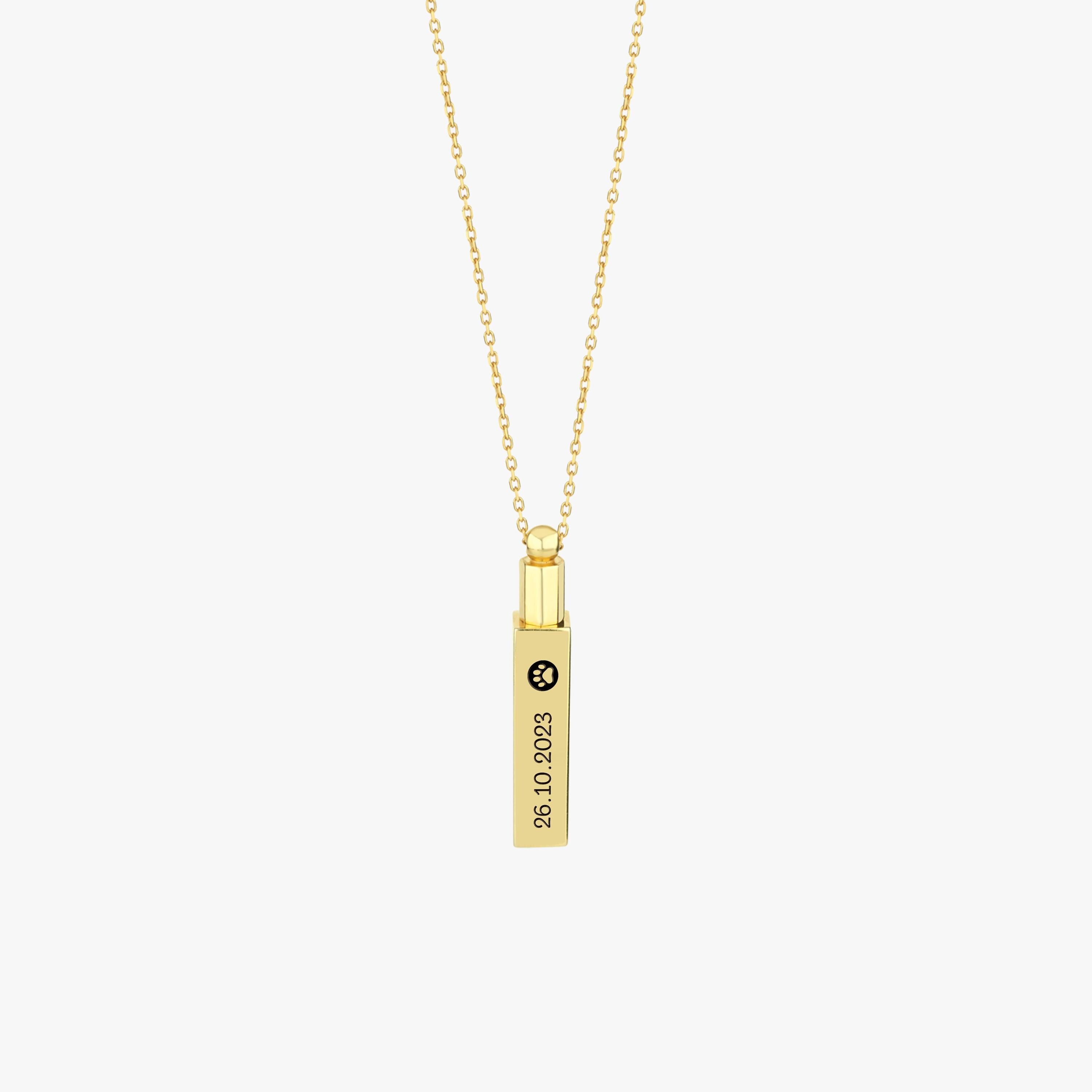 Close-up of 14K gold plated personalized cremation urn necklace with vertical engraving.