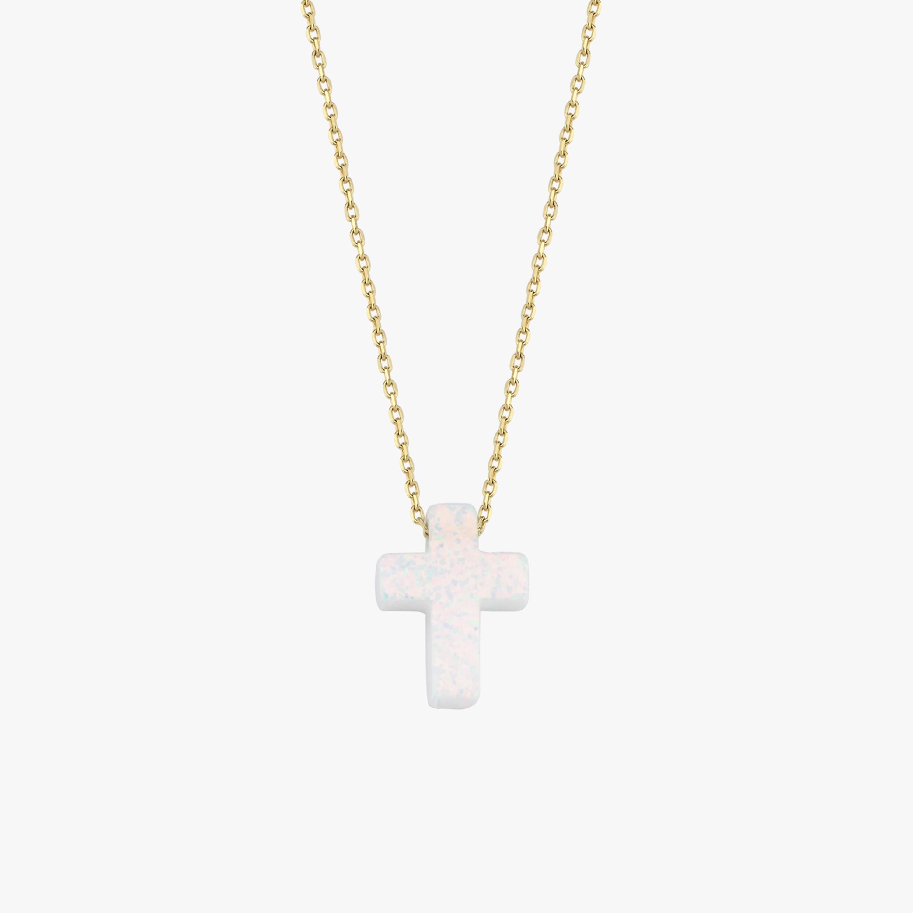 Minimalist studio view of a 14K solid gold necklace with a polished white opal cross pendant, centered on white.