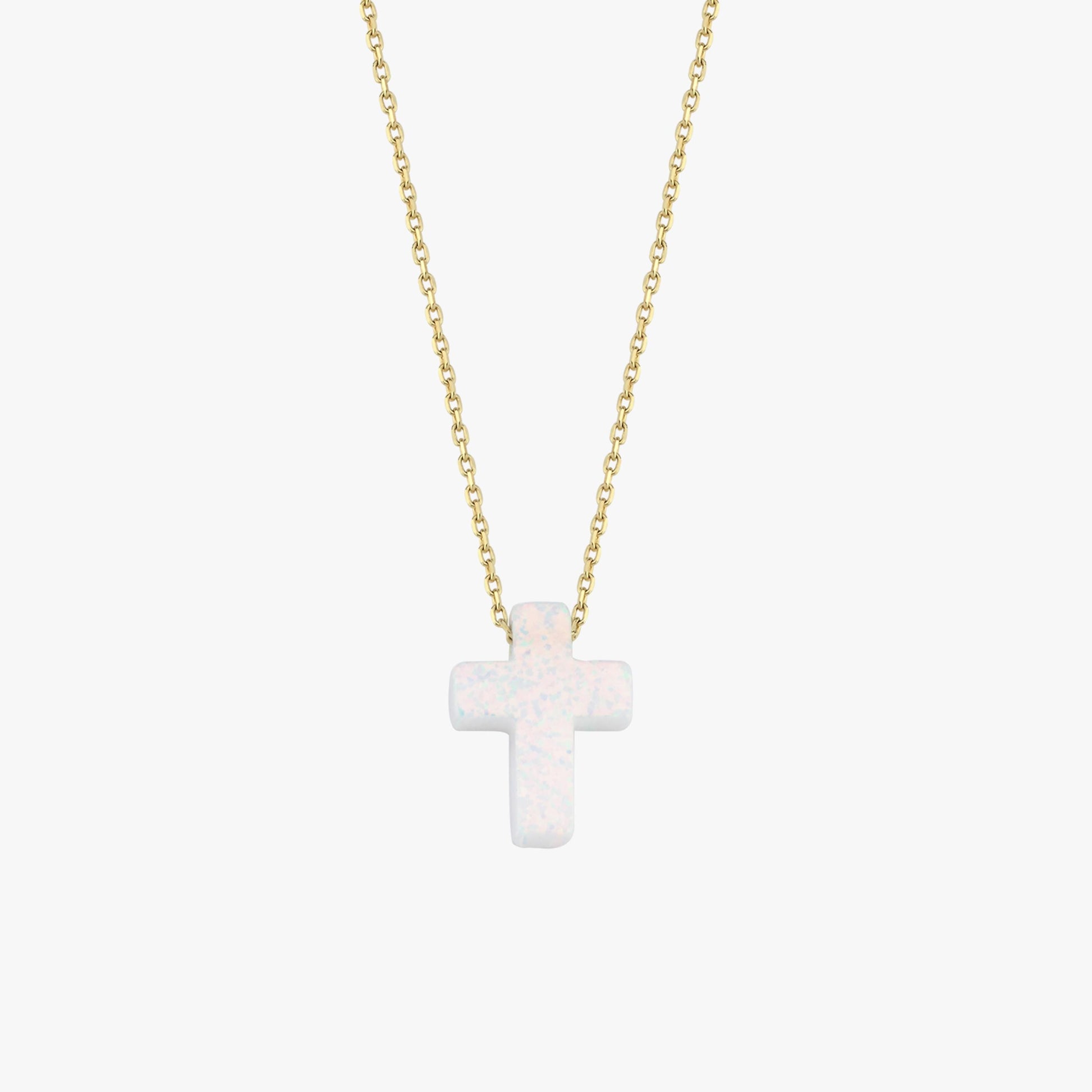 Minimalist studio view of a 14K solid gold necklace with a polished white opal cross pendant, centered on white.