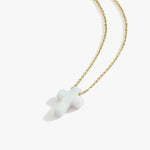 Angled studio shot of a 14K solid gold necklace featuring a white opal cross pendant on a white background.