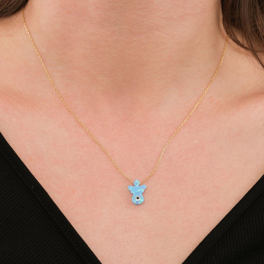 Close-up of a woman wearing a 14K solid gold opal angel necklace with a soft blue opal charm.