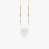 Product photo of the 14K solid gold opal Hamsa hand necklace, highlighting the sparkling opal charm.