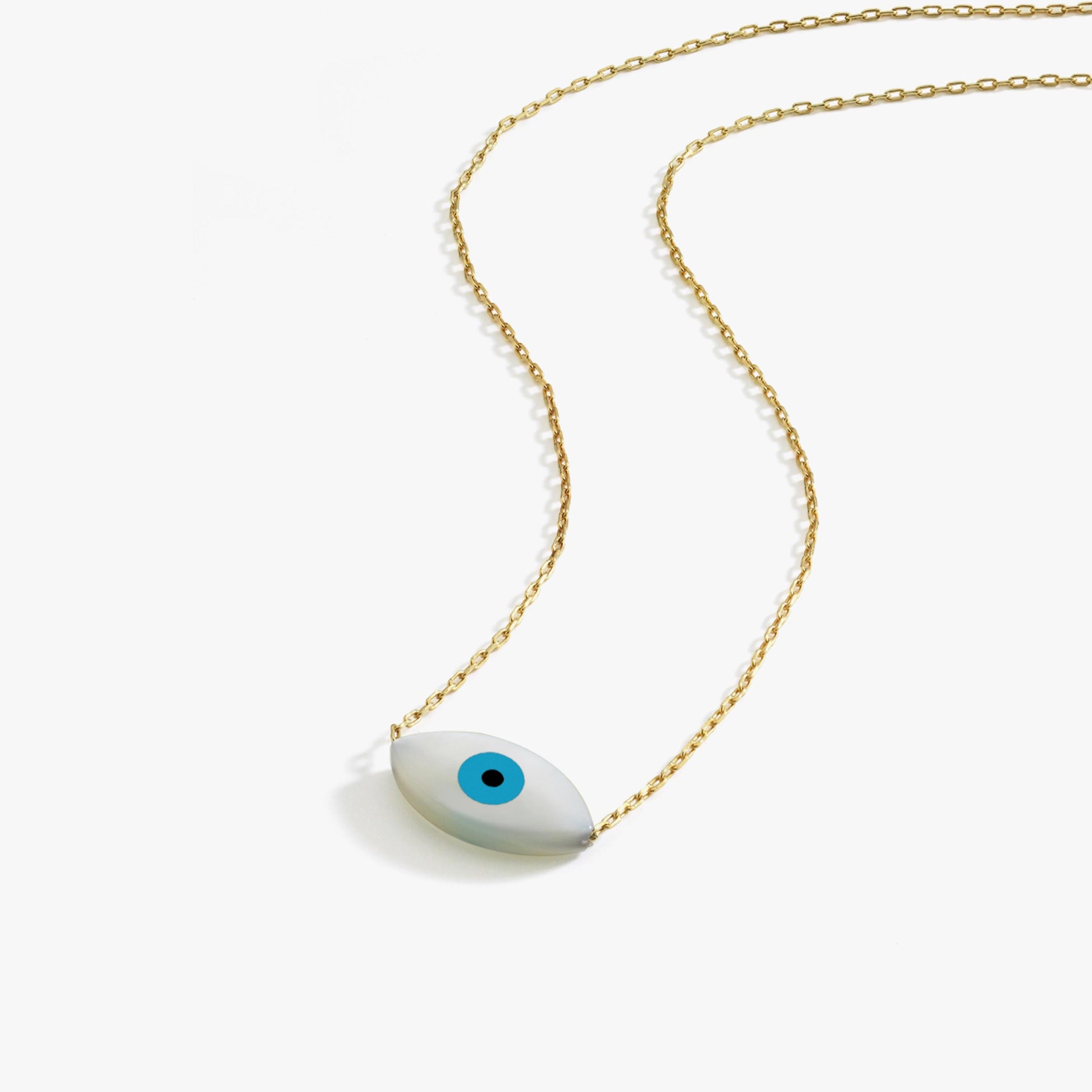 Flat lay of the 14K solid gold white opal necklace showing its smooth oval evil eye pendant with a sky-blue center.