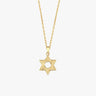 Close-up of 14K Solid Gold Magen David Necklace on collarbone.