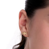 14K solid gold triple moon earrings styled on a model's ear against a white background, showcasing their symbolic and subtle elegance.
