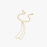 Flat lay of the 18K gold vermeil hand chain on a white background, showing its intricate design and multiple connecting strands.