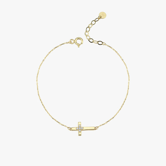 Flat-lay image of a 14K solid gold cross bracelet for women, featuring a delicate chain and diamond-detailed cross charm.