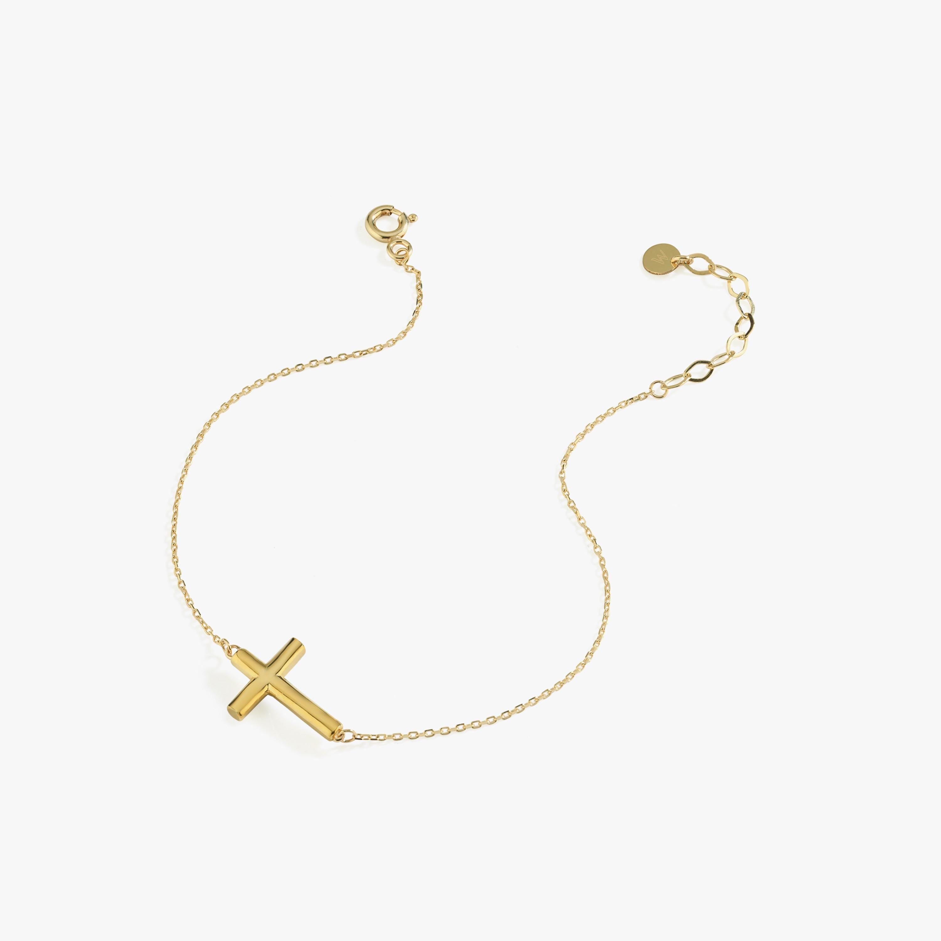 Minimalist 14K solid gold dainty cross bracelet shown on a white background, with a solid bold cross charm and adjustable chain.