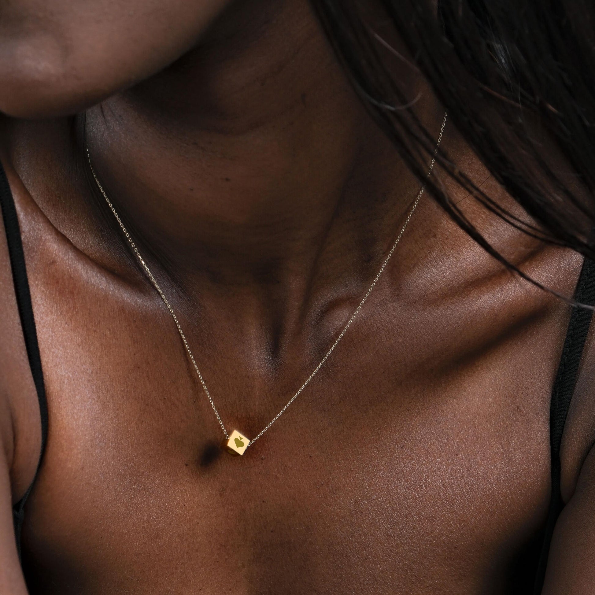 Detail shot of the 14K solid gold Spade Cards necklace