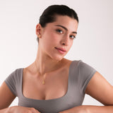 Woman wearing 14K Solid Gold Magen David Necklace with soft smile and simple style.