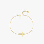 Top view of a 14K solid gold dainty cross bracelet with a thick horizontal cross, displayed in a loop on a white background.