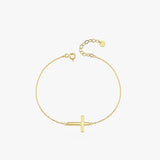 Top view of a 14K solid gold dainty cross bracelet with a thick horizontal cross, displayed in a loop on a white background.