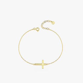 Top view of a 14K solid gold dainty cross bracelet with a thick horizontal cross, displayed in a loop on a white background.