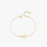 Top view of a 14K solid gold dainty cross bracelet with a thick horizontal cross, displayed in a loop on a white background.