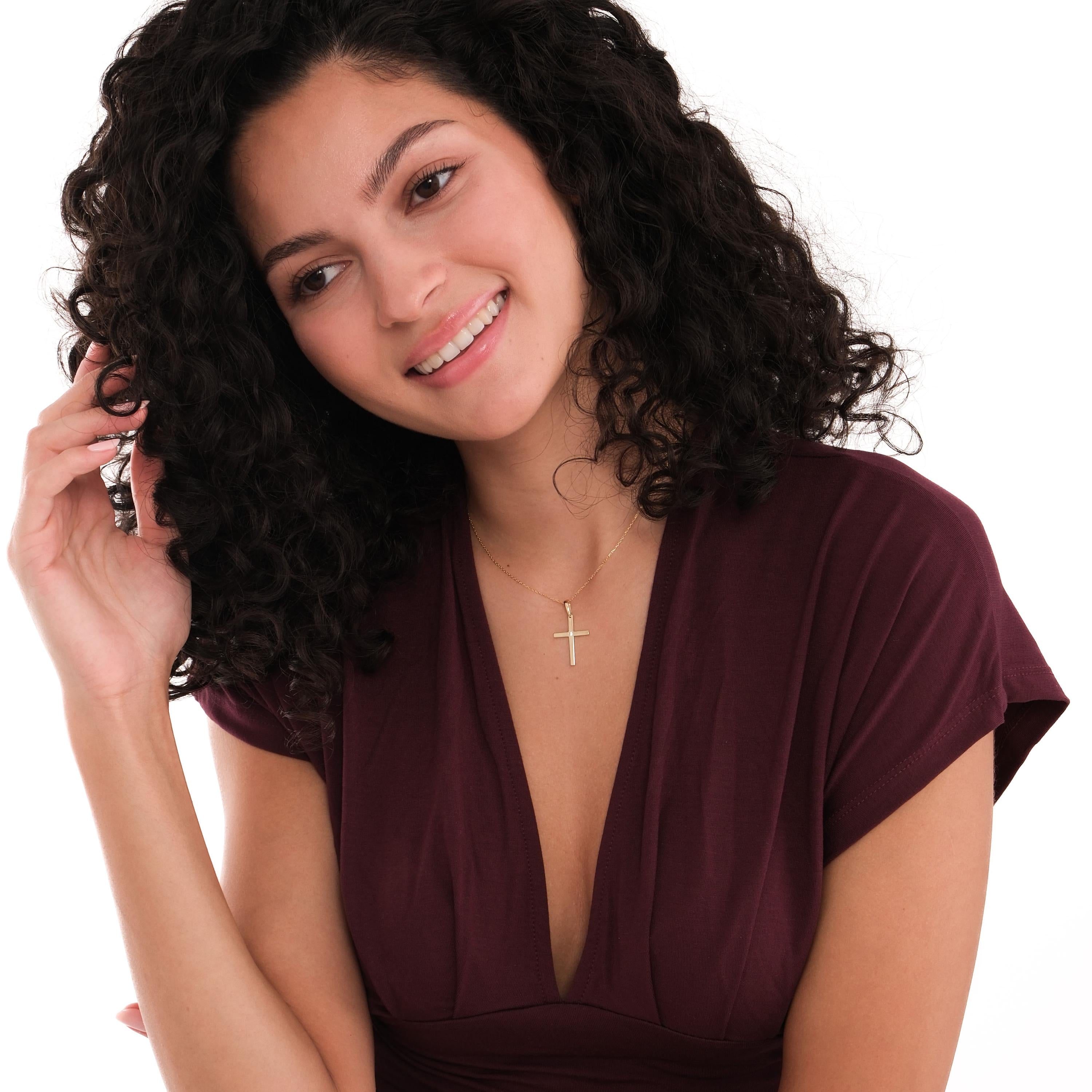 Smiling woman with curly hair wearing the 18K Gold Vermeil Cross Necklace.