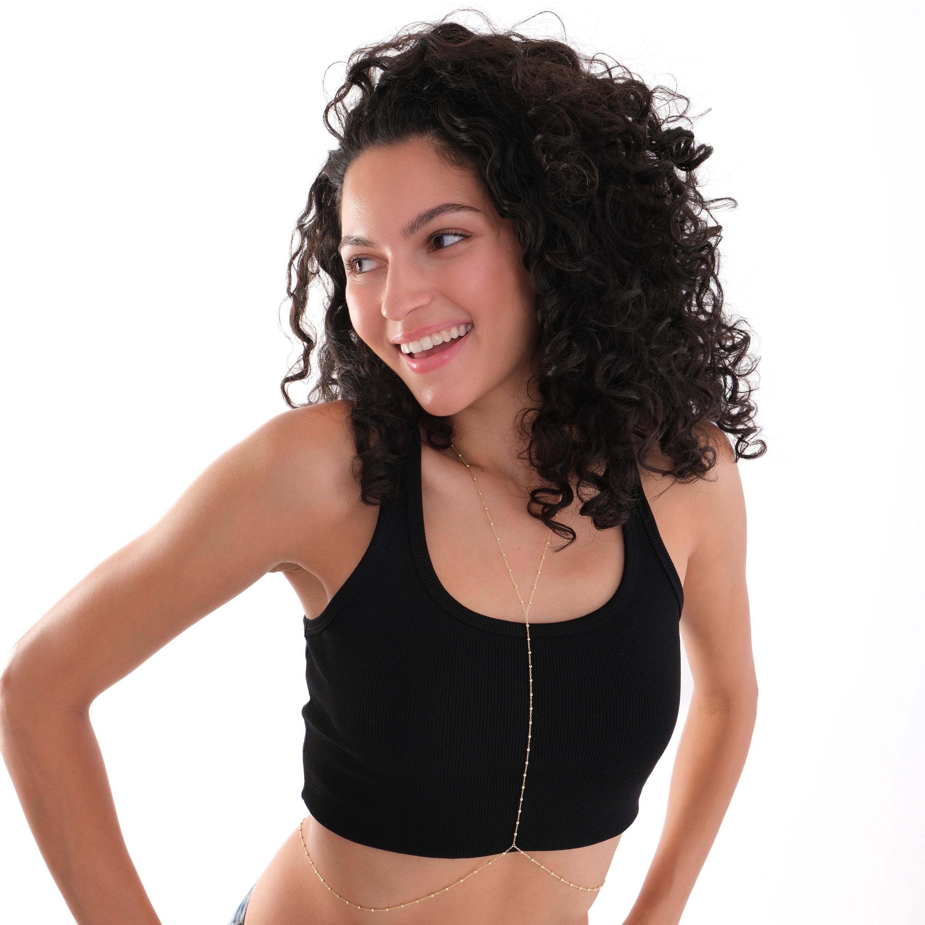 Model in a relaxed pose wearing the 18K Gold Vermeil Beaded Body Chain draped over her body.