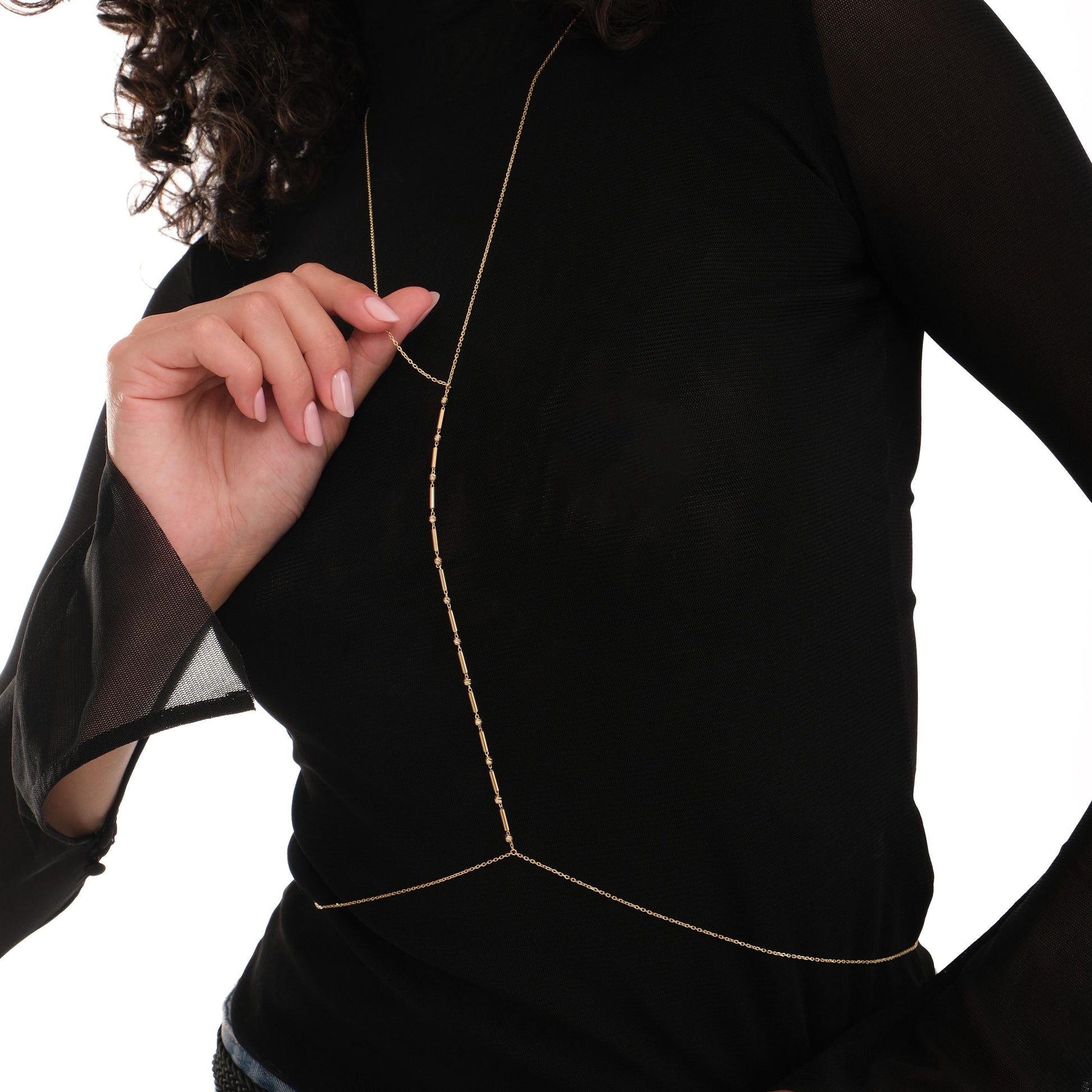 Close-up of 18K Gold Vermeil Bar and Bead Body Jewelry styled over a sheer black top.