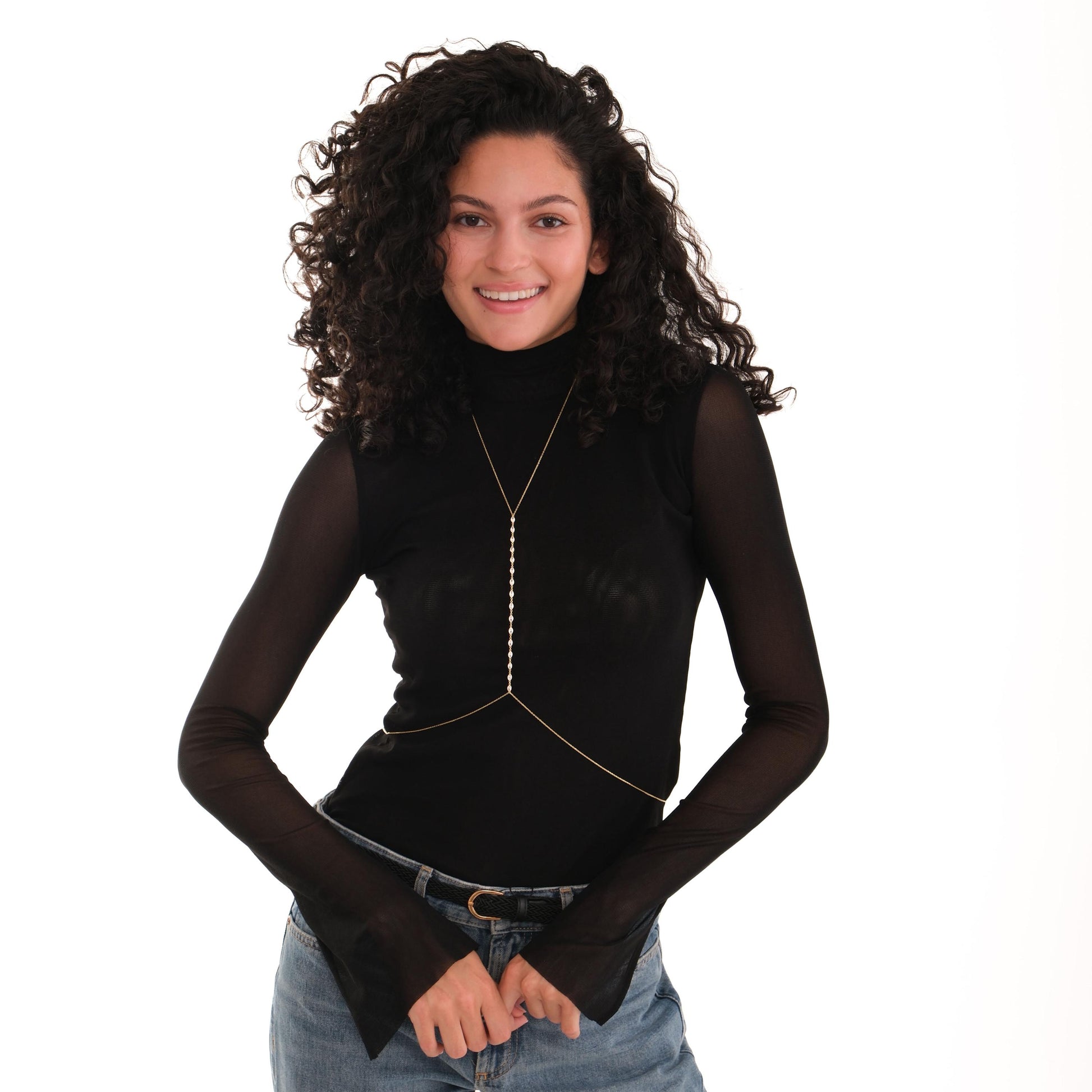 Styled over a high-neck black shirt and jeans, the 18K Gold Vermeil Body Chain Jewelry adds a subtle shine to the outfit.