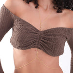 The 18K Gold Vermeil Body Chain with Heart drapes softly along the model’s torso, highlighting its minimalist heart detailing.