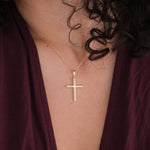 Close-up of the 18K Gold Vermeil Cross Necklace on a woman’s neck.