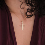Close-up of the 18K Gold Vermeil Cross Necklace on a woman’s neck.