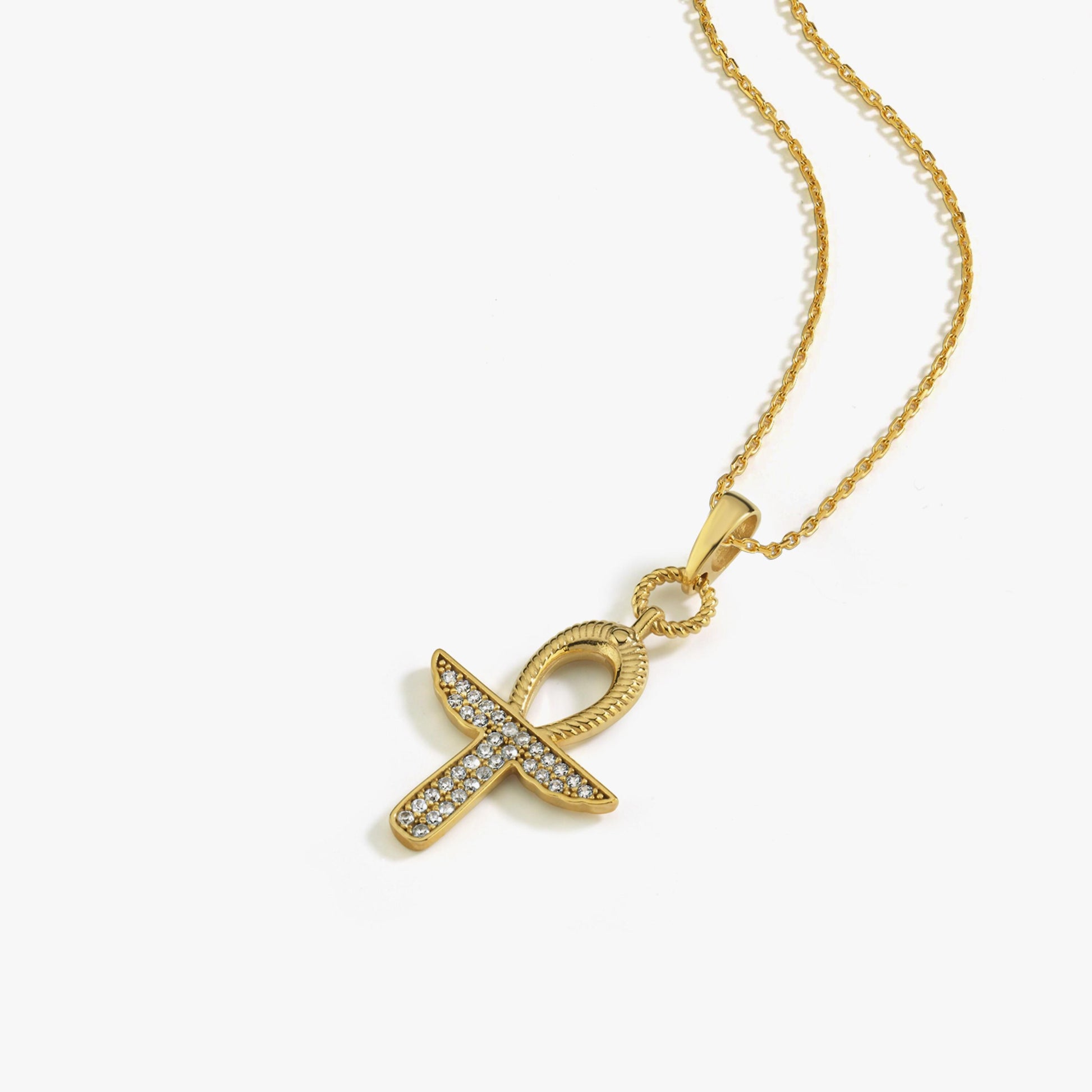 A smiling model wears the 18K Gold Vermeil Ankh Necklace, showcasing its meaningful and stylish presence.