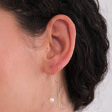Close-up of 14K Solid Gold Threader Earrings with Real Pearl worn on the ear.