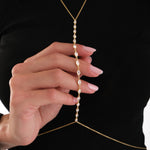 Close-up of the model holding the chain, showing the fine stones and gold finish of the 18K Gold Vermeil Body Chain Jewelry.