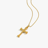 Flat-lay of the 18K Gold Vermeil Cross Necklace, showcasing the polished cross pendant on a delicate gold chain.