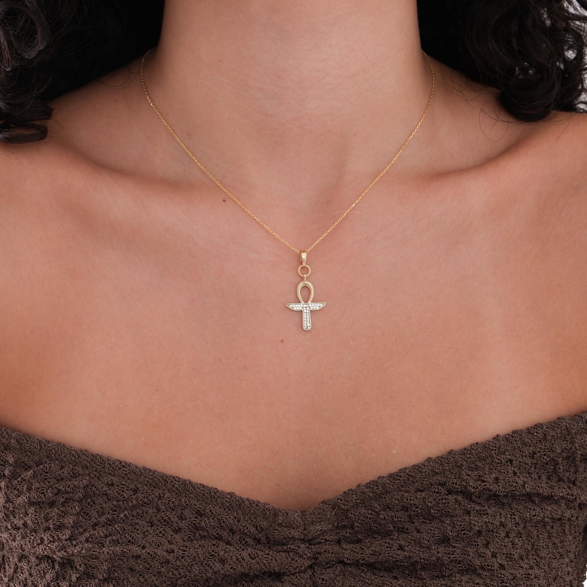 The 18K Gold Vermeil Ankh Necklace is displayed on a white background, highlighting its crystal-studded ancient Egyptian symbol.