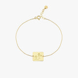Circularly laid 14K solid gold Kids Handwriting Bracelet showing the engraved child-like illustration and text.
