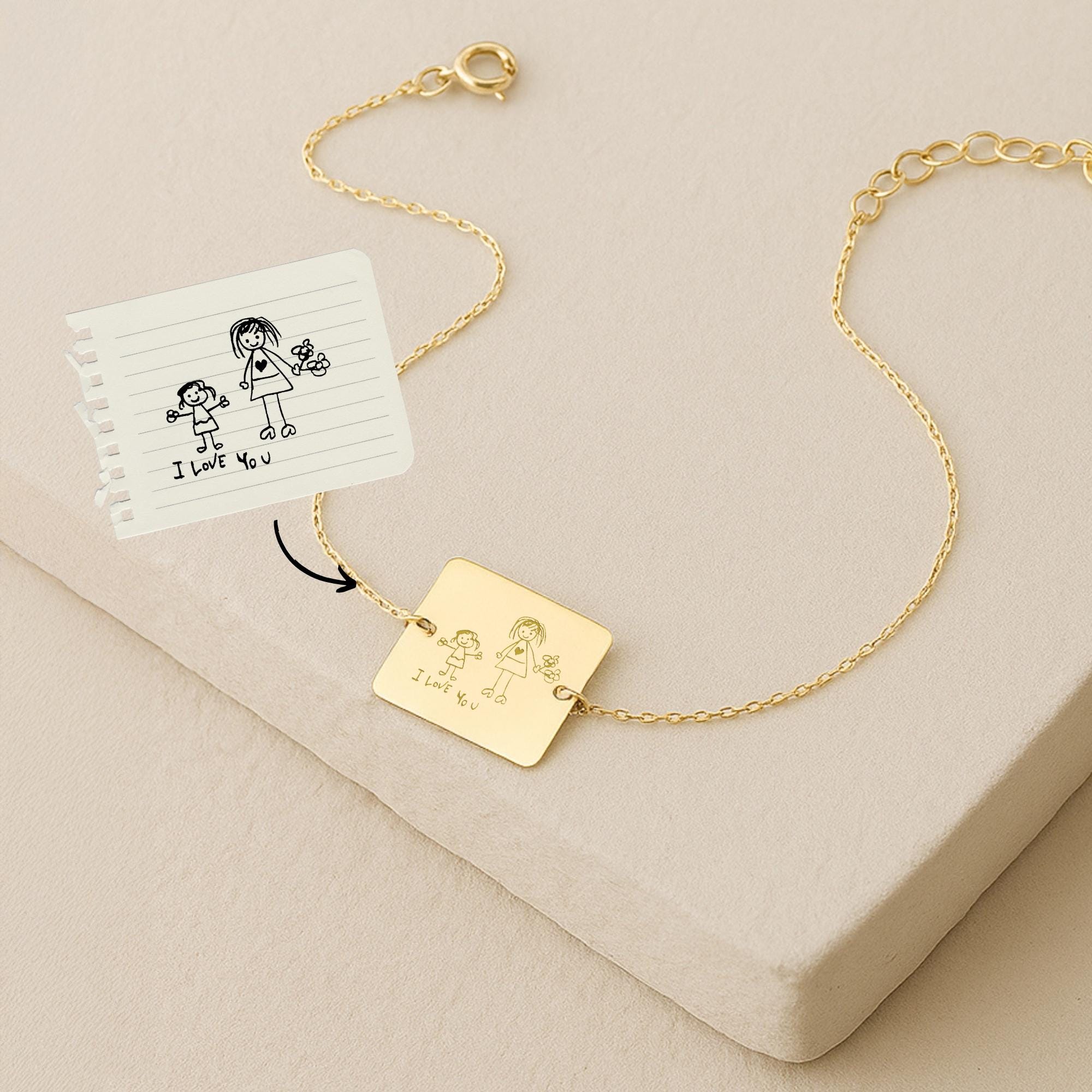14K solid gold Kids Handwriting Bracelet featuring an engraved child's drawing that matches the original sketch shown beside it.