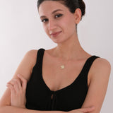 A timeless 14K gold necklace expressing positivity, style, and personal meaning.