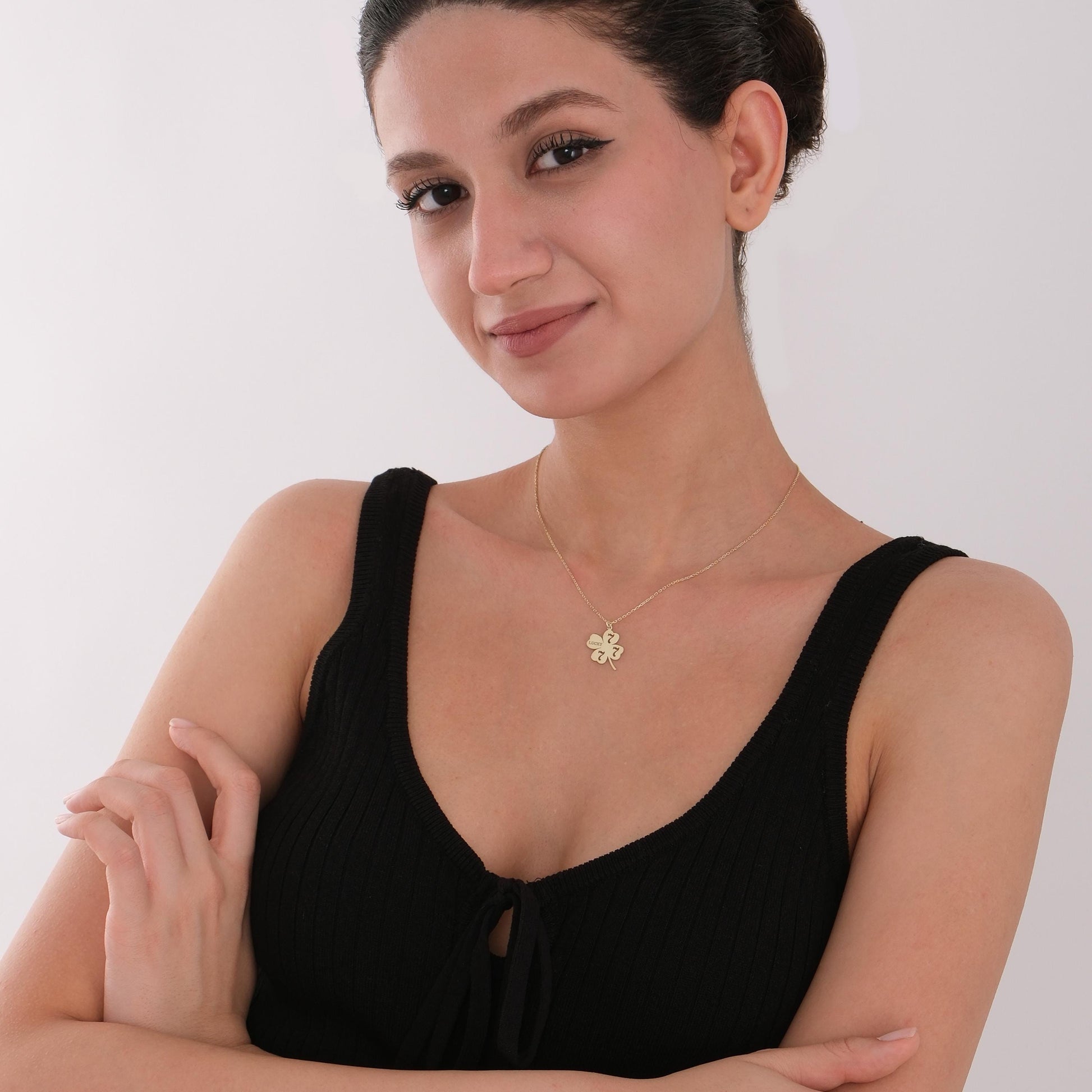 A timeless 14K gold necklace expressing positivity, style, and personal meaning.