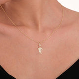 14K solid gold boy charm necklace engraved with the name “Thomas”, worn close to the heart.