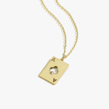 Flat lay of the 14K Solid Gold Playing Card Necklace showing the pendant’s cutout design.